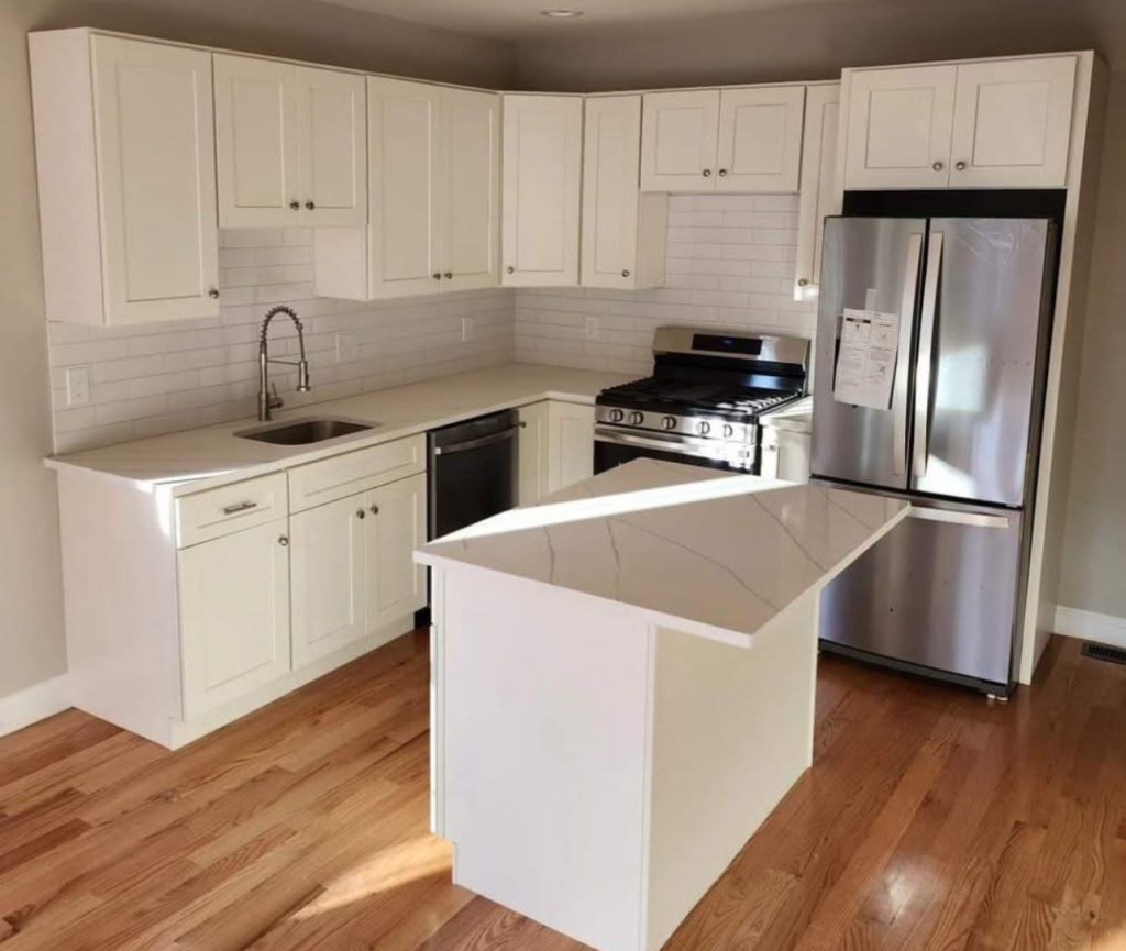 Remodeled white kitchen with island in Massachusetts