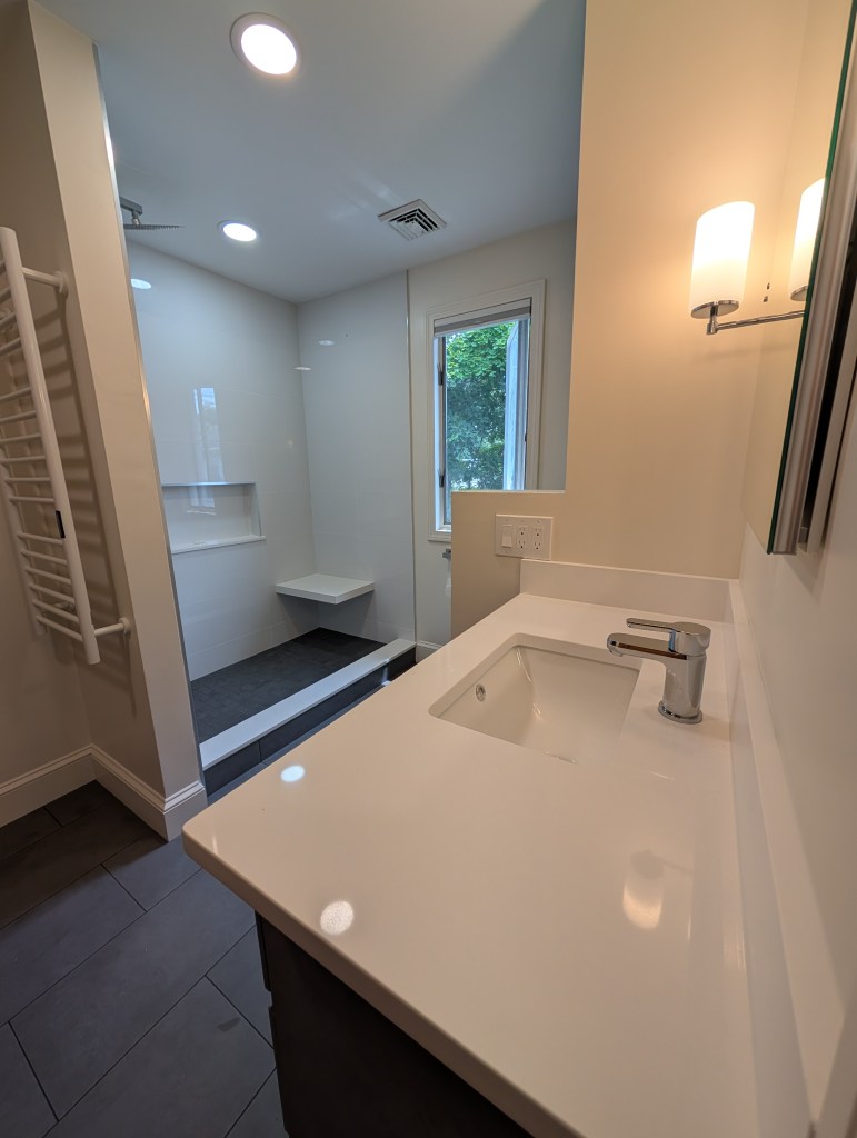 Remodeled bathroom with walk-in shower and vanity