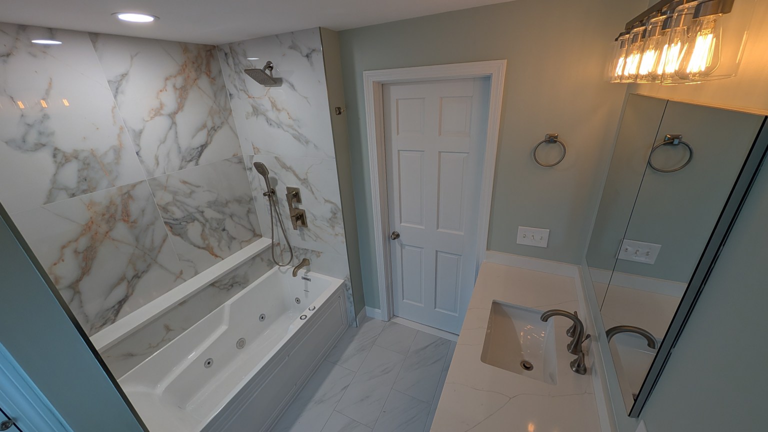Bathroom remodel with marble tub surround in Greater Boston