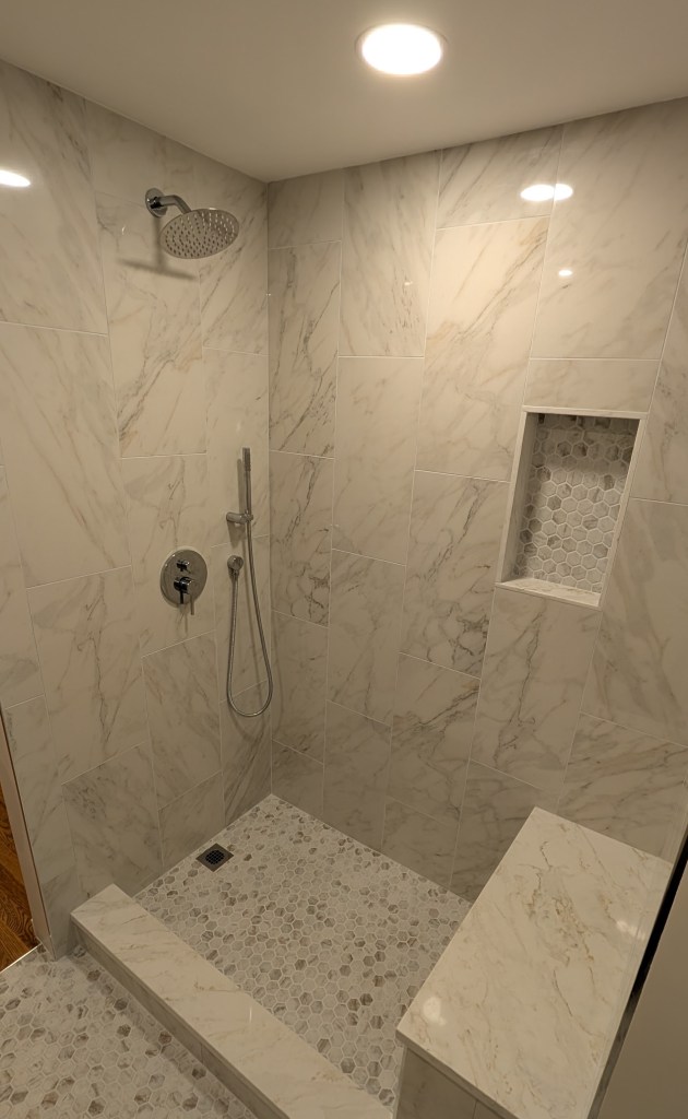 Finished tub to walk-in shower conversion with a built-in bench and niche in Melrose, MA